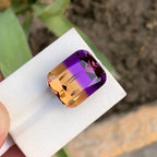 ametrine gemstone on a white stand with a blurred natural background