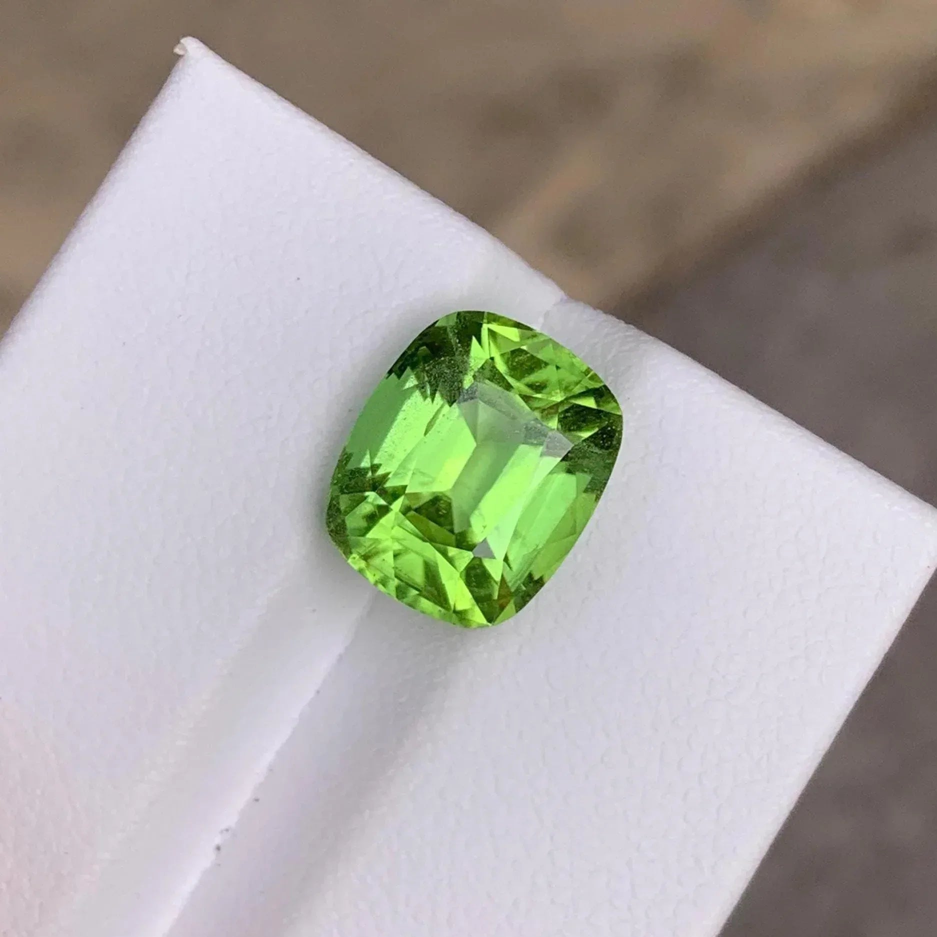 Faceted Cushion Cut Peridot Gemstone: 6.10 Carats, Pakistan Origin - Splendor Gems