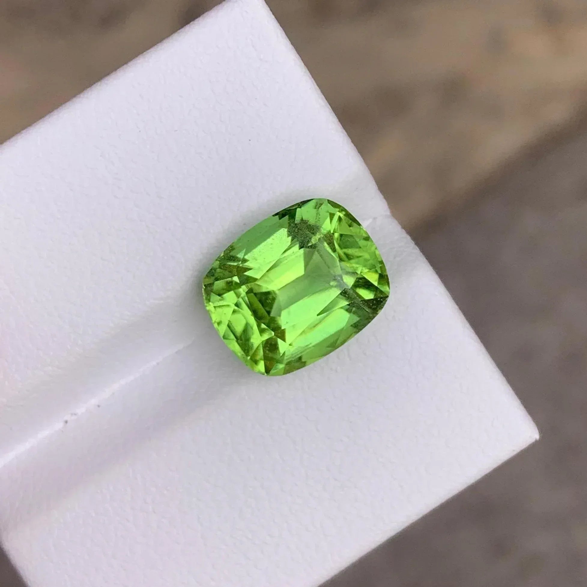 Faceted Cushion Cut Peridot Gemstone: 6.10 Carats, Pakistan Origin - Splendor Gems