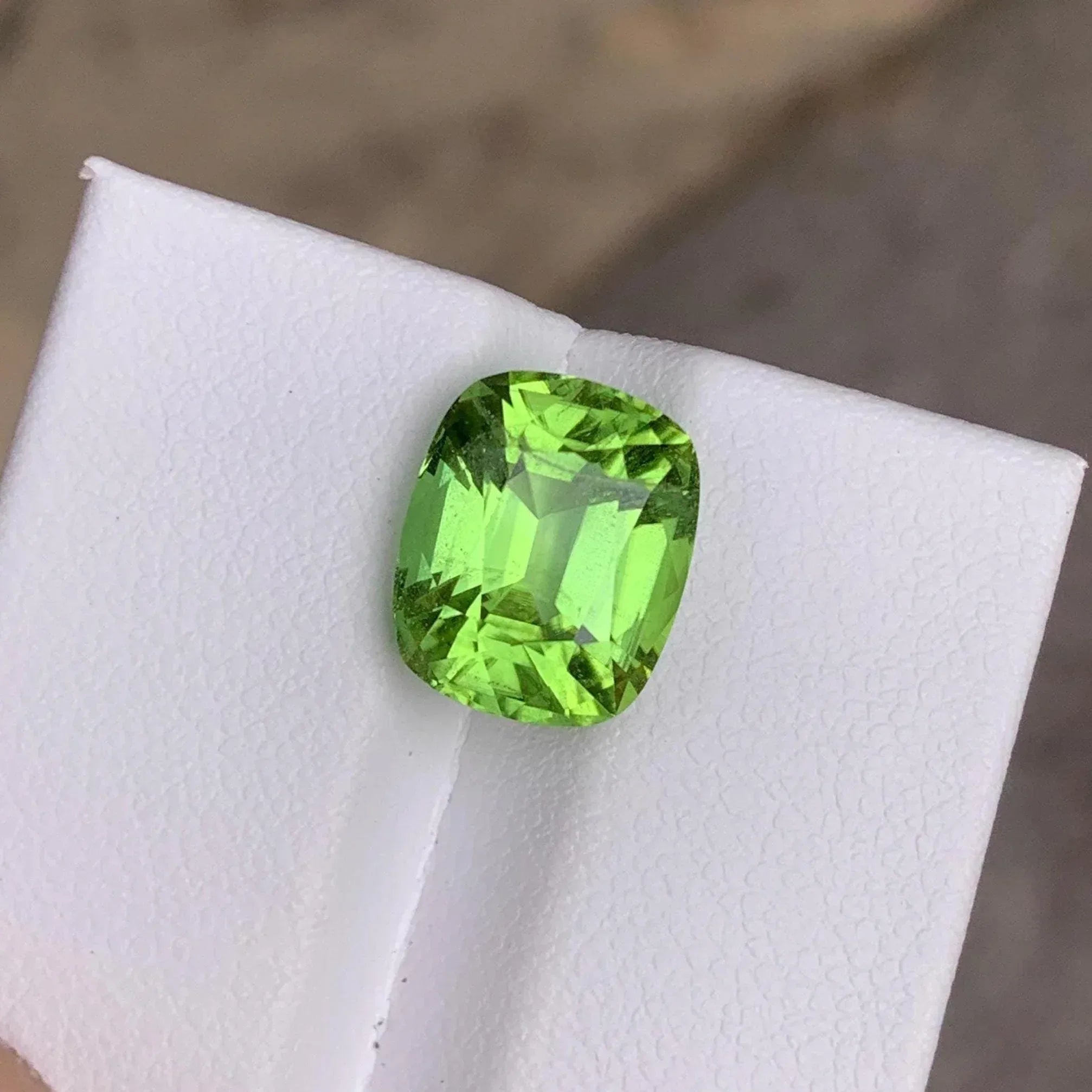 Faceted Cushion Cut Peridot Gemstone: 6.10 Carats, Pakistan Origin - Splendor Gems