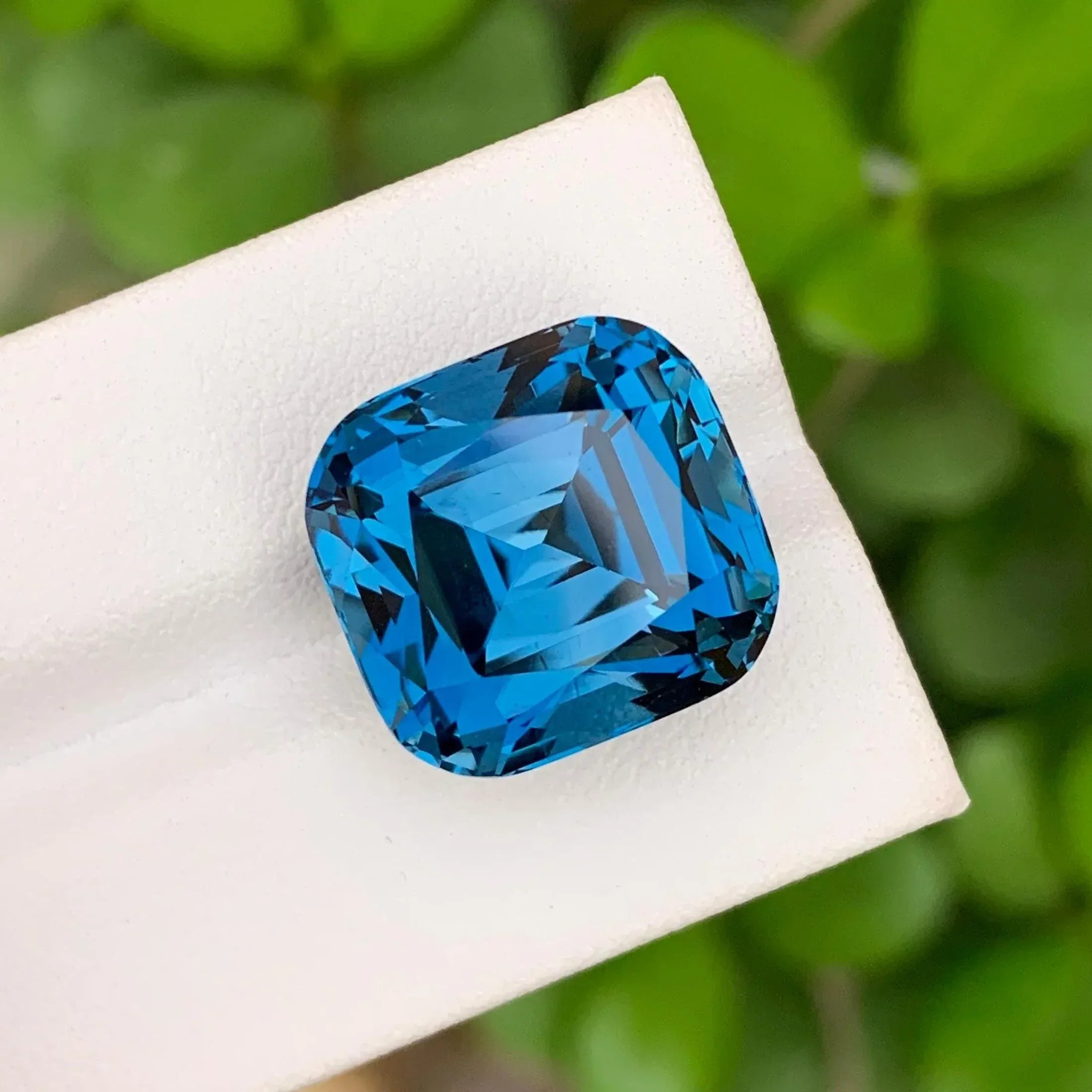 28.60 Carat Neon Blue Topaz: Faceted Cushion Cut Gemstone - Splendor Gems