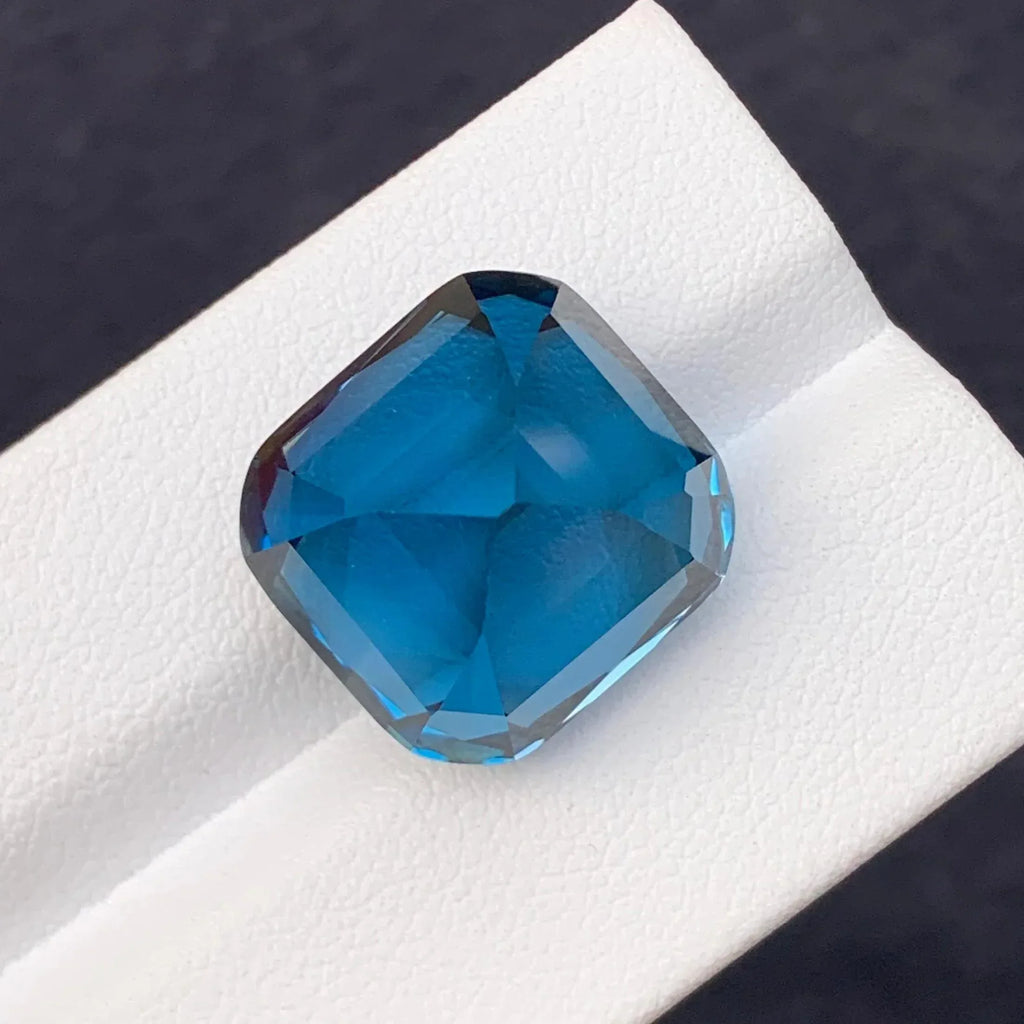 28.60 Carat Neon Blue Topaz: Faceted Cushion Cut Gemstone - Splendor Gems