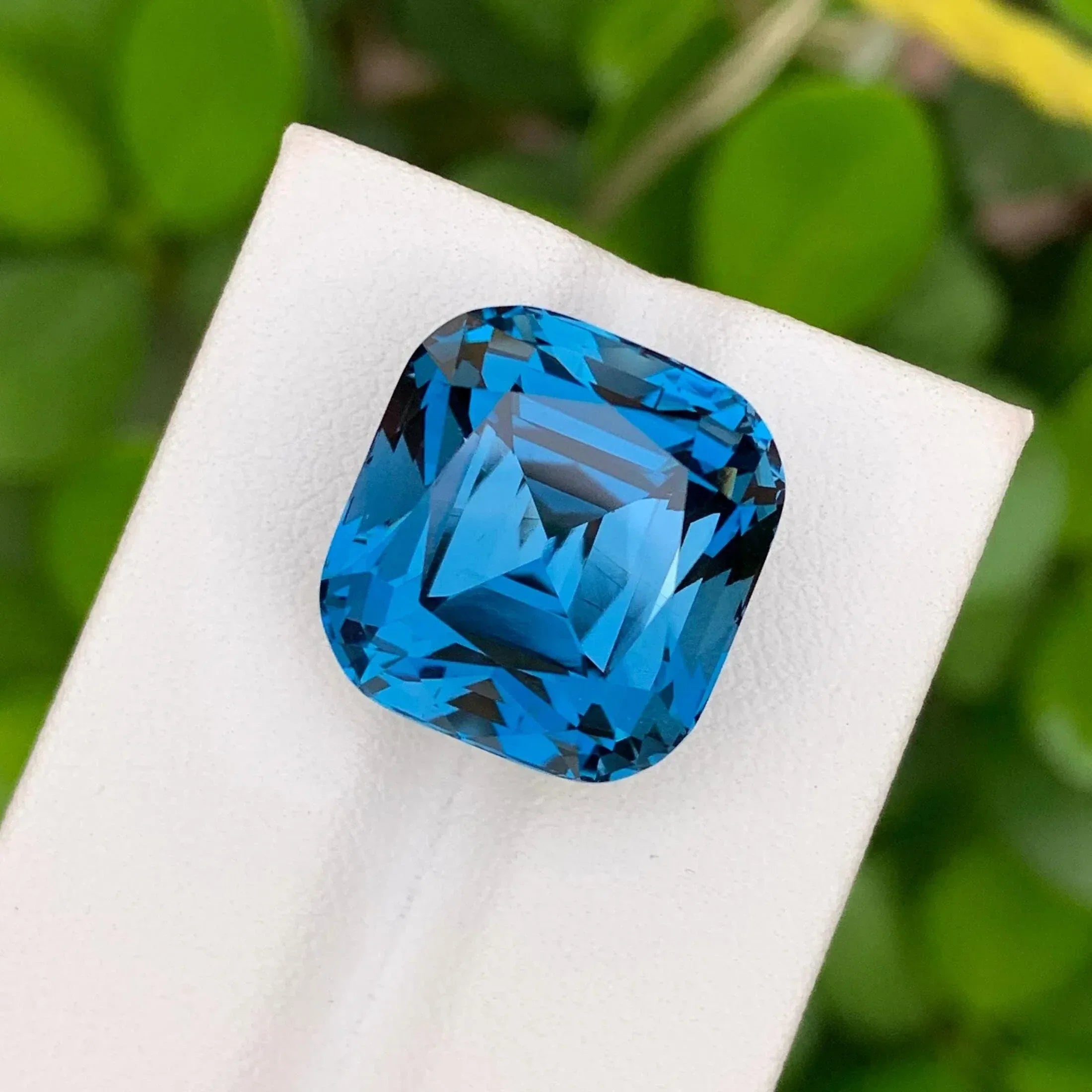 28.60 Carat Neon Blue Topaz: Faceted Cushion Cut Gemstone - Splendor Gems