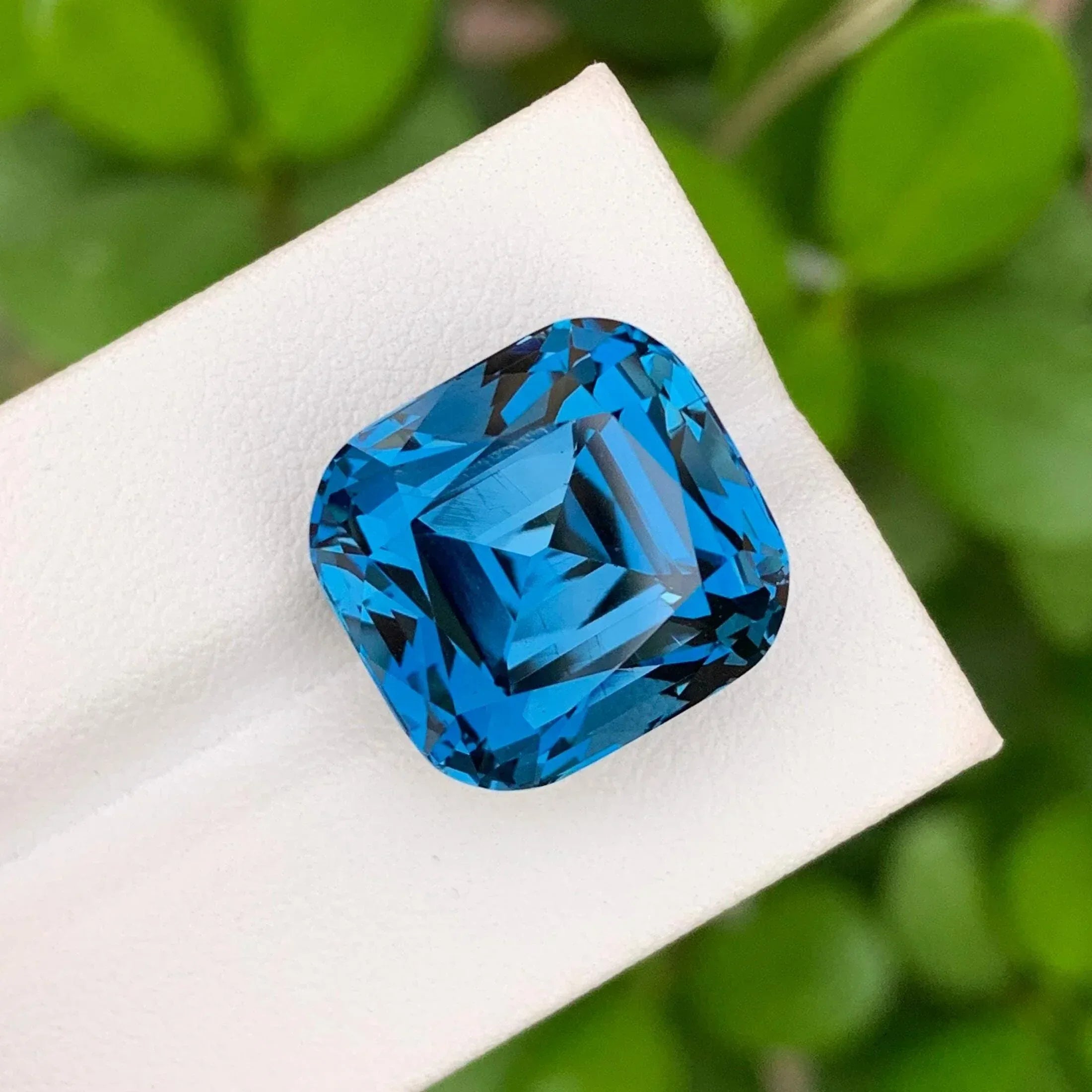 28.60 Carat Neon Blue Topaz: Faceted Cushion Cut Gemstone - Splendor Gems