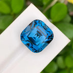 28.60 Carat Neon Blue Topaz: Faceted Cushion Cut Gemstone - Splendor Gems