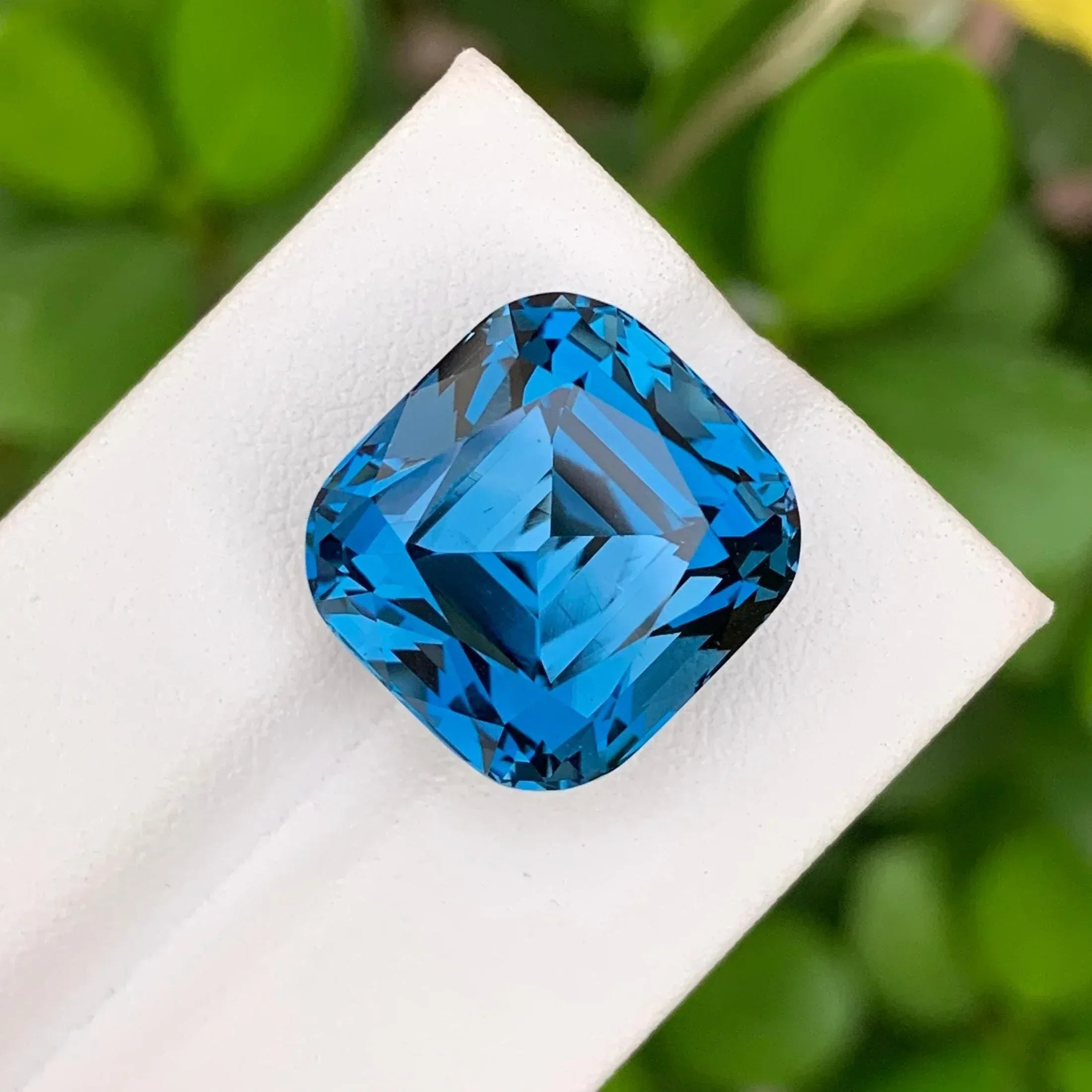 28.60 Carat Neon Blue Topaz: Faceted Cushion Cut Gemstone - Splendor Gems